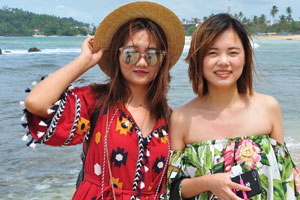 Two amazing chinese ladies struck poses on Mirissa beach