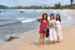 Three gorgeous chinese ladies struck poses on Mirissa beach