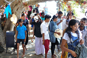 People walk beside the Ravana statue