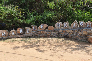 The name of the beach is painted on the boulders