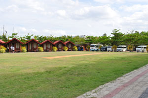 A big green lawn of JKAB Beach Resort