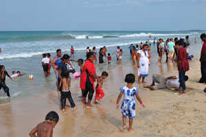 A crowd of local people enjoy the beach