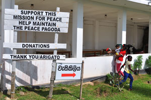 The inscription reads “Support this mission for peace, Help maintain the Peace Pagoda”