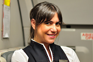 A beautiful flight attendant from the Iberia (IB) airline is on the flight from Madrid to Moscow