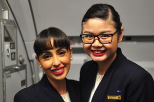 Two female flight attendants of unfathomable beauty are from Qatar Airways