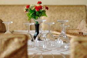 Empty wine glasses are upside down on the table in kitchen in the Magnificat hotel