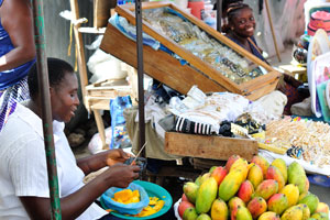 A charming female vendor sells mango at Grand Market