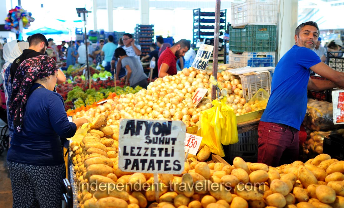 A male vendor sells potato