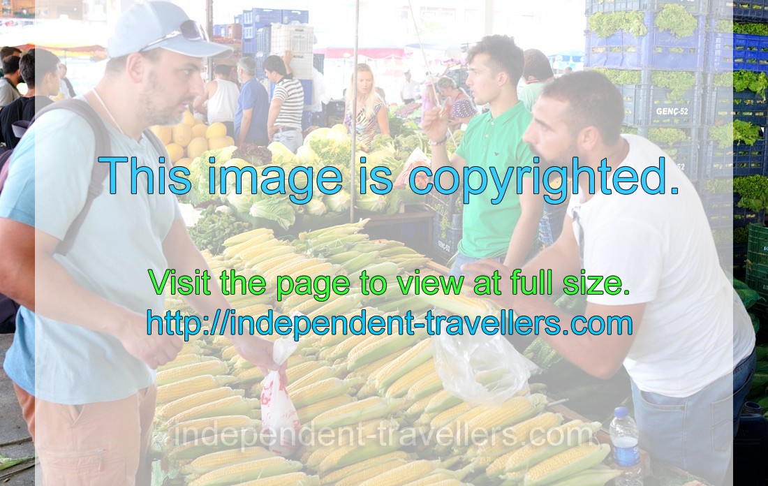 Male vendors sell corn cobs