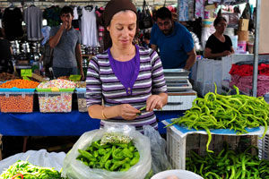 A female vendor sells asparagus
