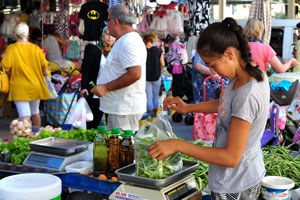 A young Turkish girl sells green beans