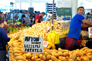 A male vendor sells potato
