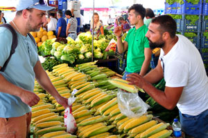 Male vendors sell corn cobs