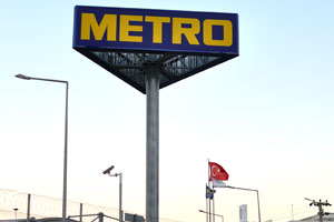 The inscription on the three-sided giant billboard reads Metro