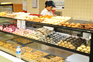 A Turkish lady works as a vendor in the bakery of 5M Migros hypermarket