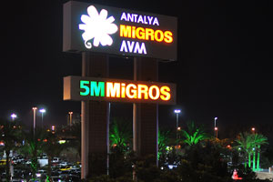 The illuminated sign of 5M Migros is very bright at night