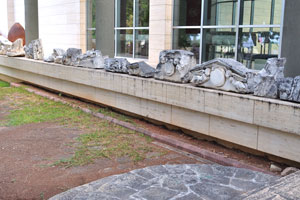 The open-air exhibition area features excavation fragments