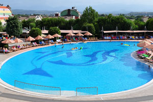 The water pool is surrounded with the sun loungers