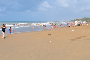 The sunny beach is sandy
