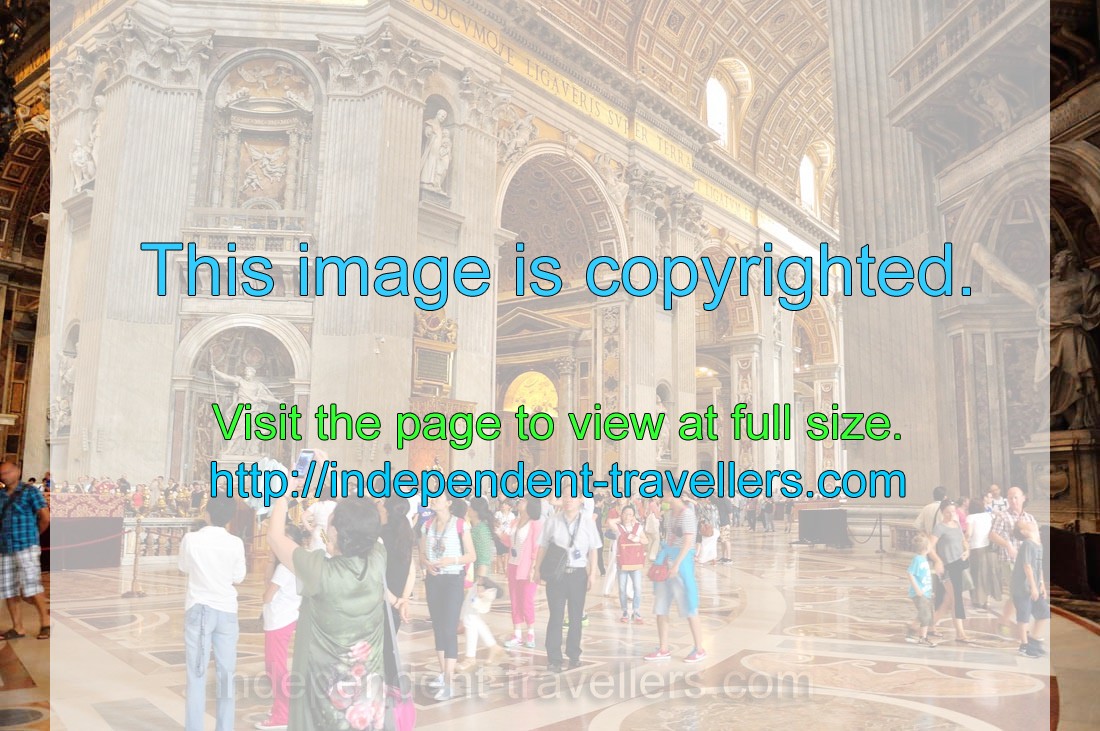 Tourists are in the nave of St. Peter's Basilica
