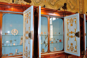 Blue cabinets with artifacts are in the Sacred Museum of the Vatican Apostolic Library