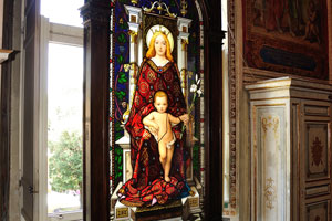 A colorful stained glass window with mother and child is in the Vatican Apostolic Library