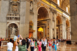 Tourists are in the nave of St. Peter's Basilica