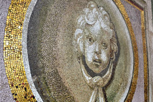 Mosaic of a child face is in the entryway to the ticket office of the dome