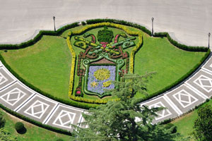 The “Papal coat of arms” flower bed is in front of the Palace of the Governorate of Vatican City State