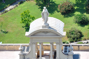 A statue is on the top of the Palace of the Governorate