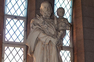 The statue of a saint with a child is inside St. Mary's Cathedral Basilica