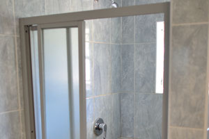 The shower is inside the bathroom of a chalet in Caravan Park Chalets & Campsite