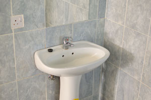The wash basin is inside the bathroom of a chalet in Caravan Park Chalets & Campsite
