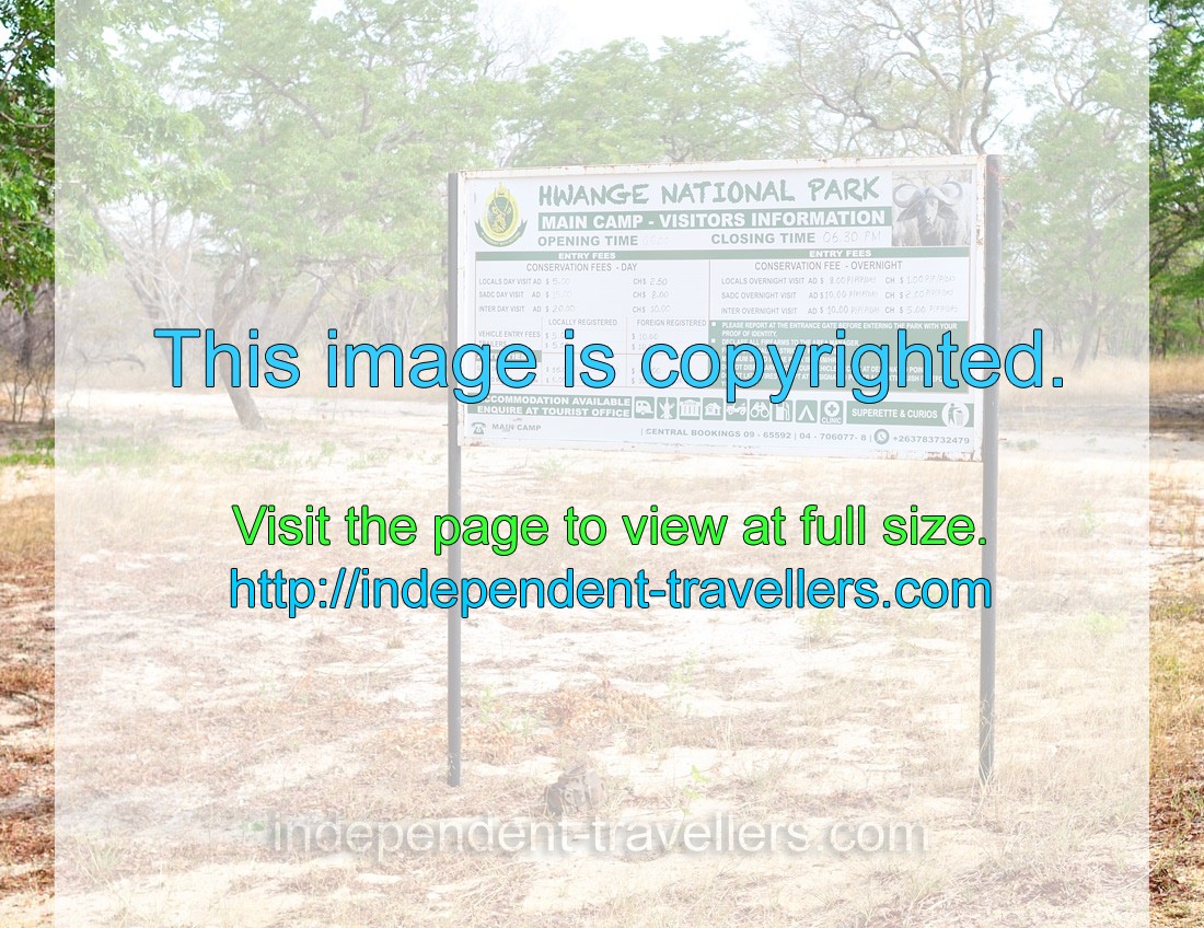 An information board reads: “Hwange National Park”