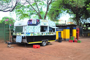 The mobile coffee van is located at the Shoestrings Backpackers Lodge